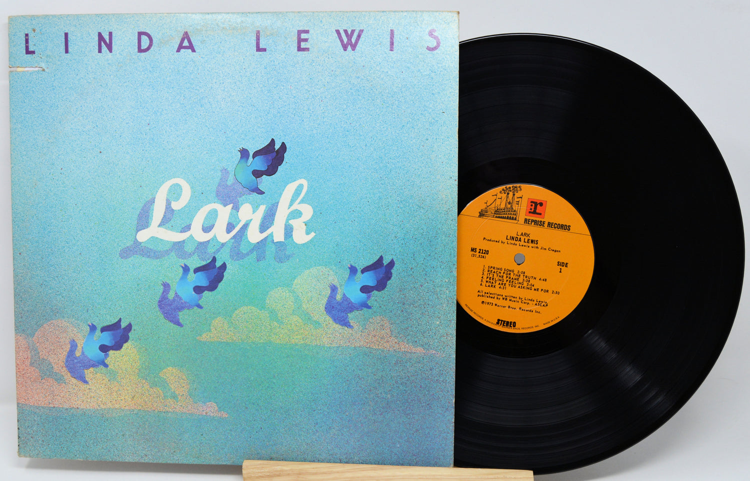 Vinyl record with a blue cover featuring two people and a visible label.