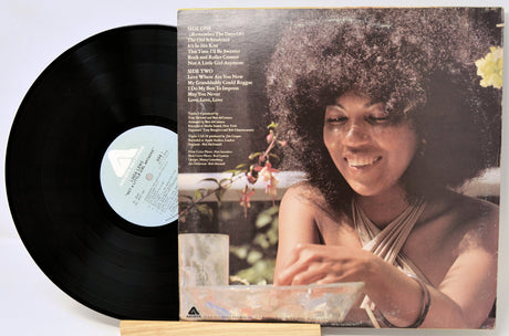Vinyl record with a cover featuring a person and text on a white background