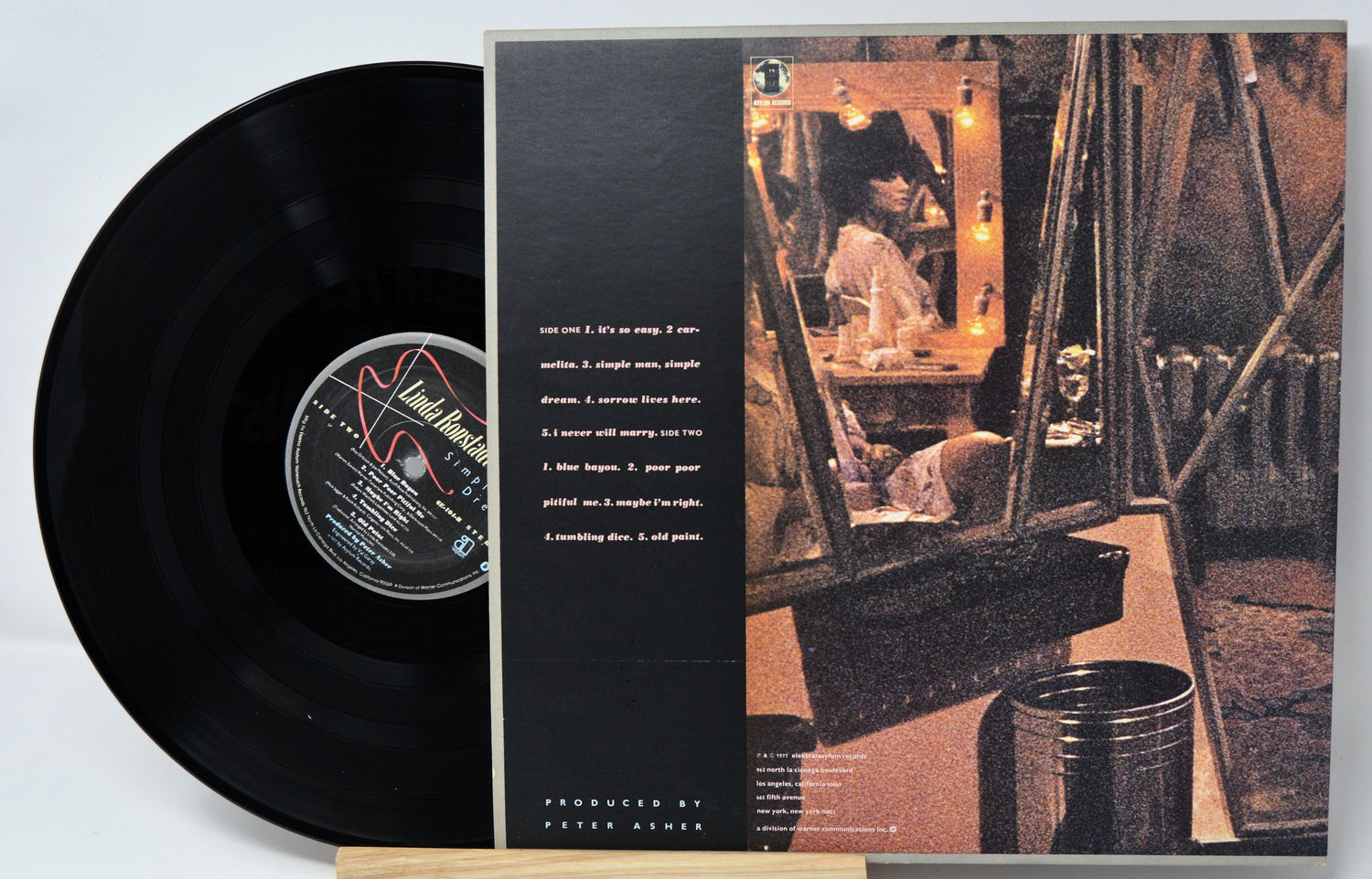 Vinyl record with cover featuring a person in a room with a mirror.
