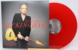 Lindsey Buckingham's 'Seeds We Sow' 12-inch vinyl record shown with its album cover and a translucent red vinyl disc on a white background.