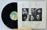 Vinyl record with cover featuring black and white portraits and text on a light gray background