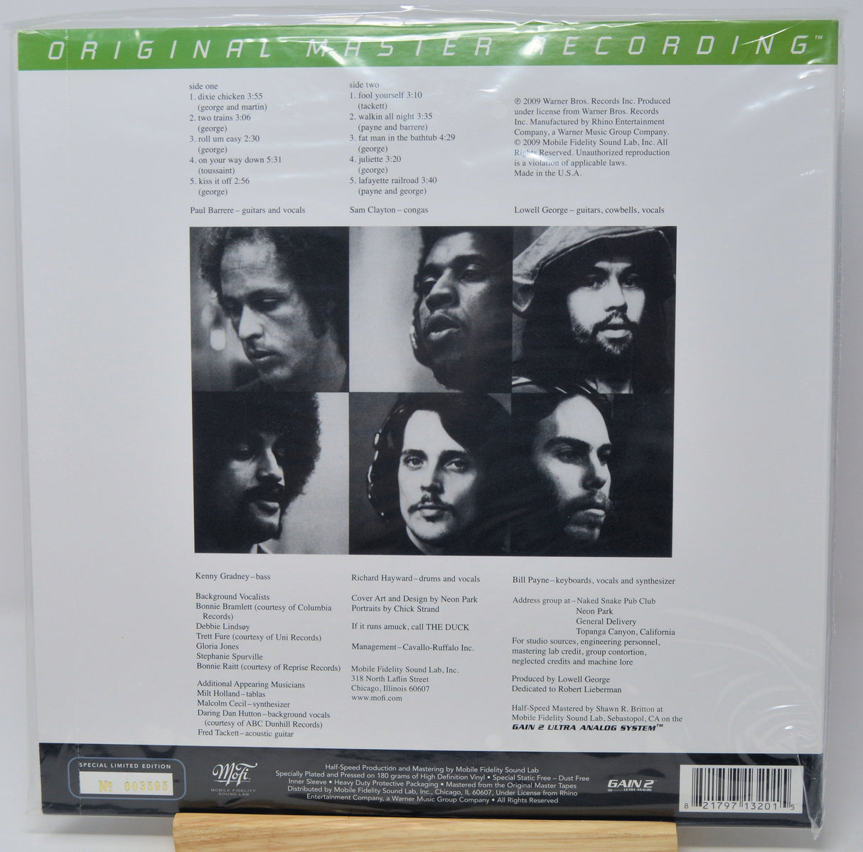 Back cover of a vinyl record sleeve for 'Original Master Recording' by The Band, featuring six black-and-white portrait photos of the band members, track listings, and a barcode on a white background.