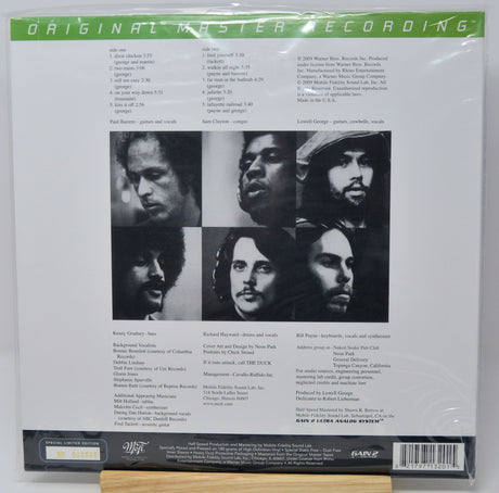 Back cover of a vinyl record sleeve for 'Original Master Recording' by The Band, featuring six black-and-white portrait photos of the band members, track listings, and a barcode on a white background.