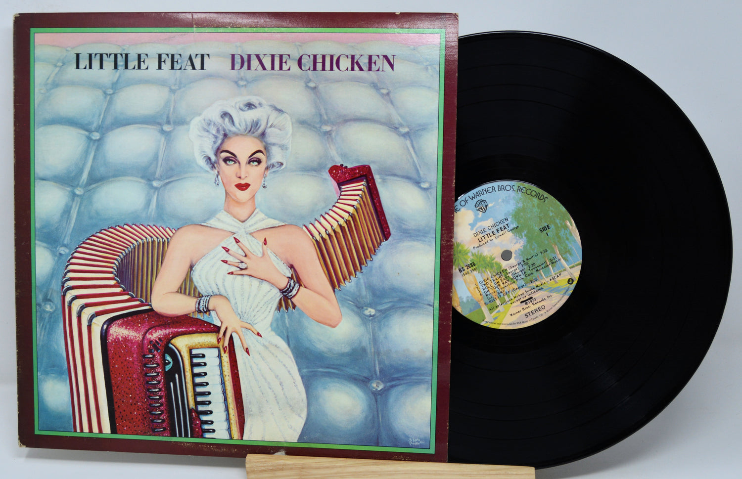 Vinyl record with cover featuring a woman playing an accordion, titled 'Dixie Chicken' by Little Feat.