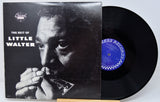 Vinyl record and cover featuring a black and white photo of a musician playing harmonica, with 'The Best Of Little Walter' text.