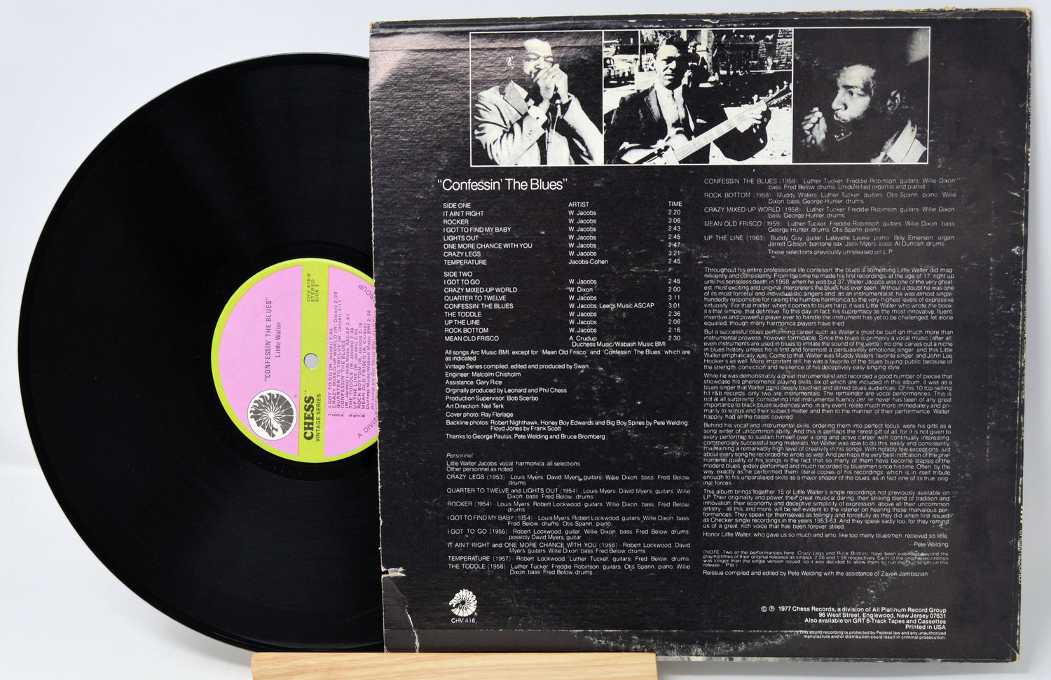 Vinyl record with cover displaying text and images on a white background