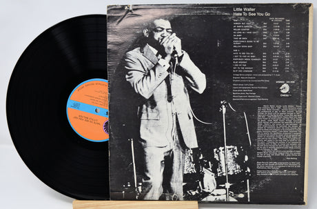 Vinyl record with cover featuring a black and white photo of a man singing into a microphone.