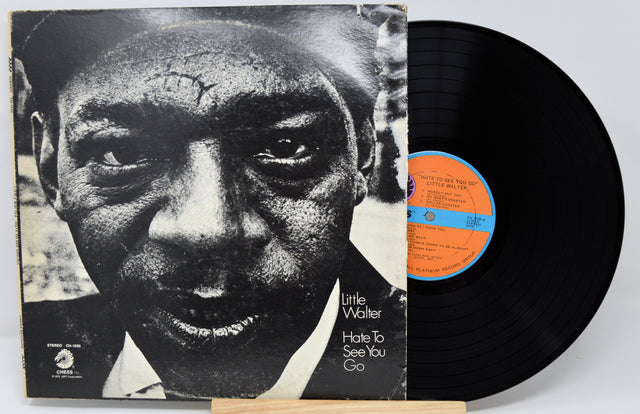 Vinyl record with cover featuring a black and white portrait and album details.