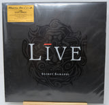 A sealed vinyl record album for 'Live - Secret Samadhi' by Music On Vinyl, featuring a black cover with a stylized dark illustration and a gold sticker in the top left corner.