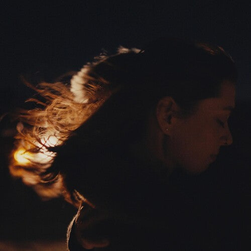 Silhouette of a person with a warm light source in the background