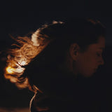 Silhouette of a person with a warm light source in the background