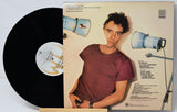 Vinyl record with a person on the cover and text on the back