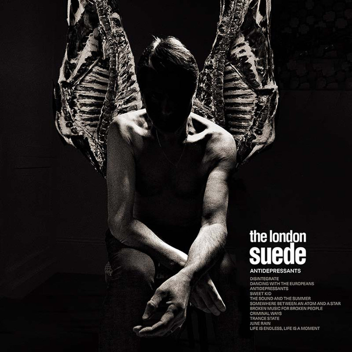 Dramatic black-and-white album cover featuring a shirtless figure with angel-like wings for London Suede's 'Antidepressants'