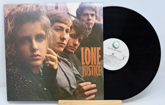 Used vinyl record album cover for Lone Justice self-titled album featuring a group photo of the band members.