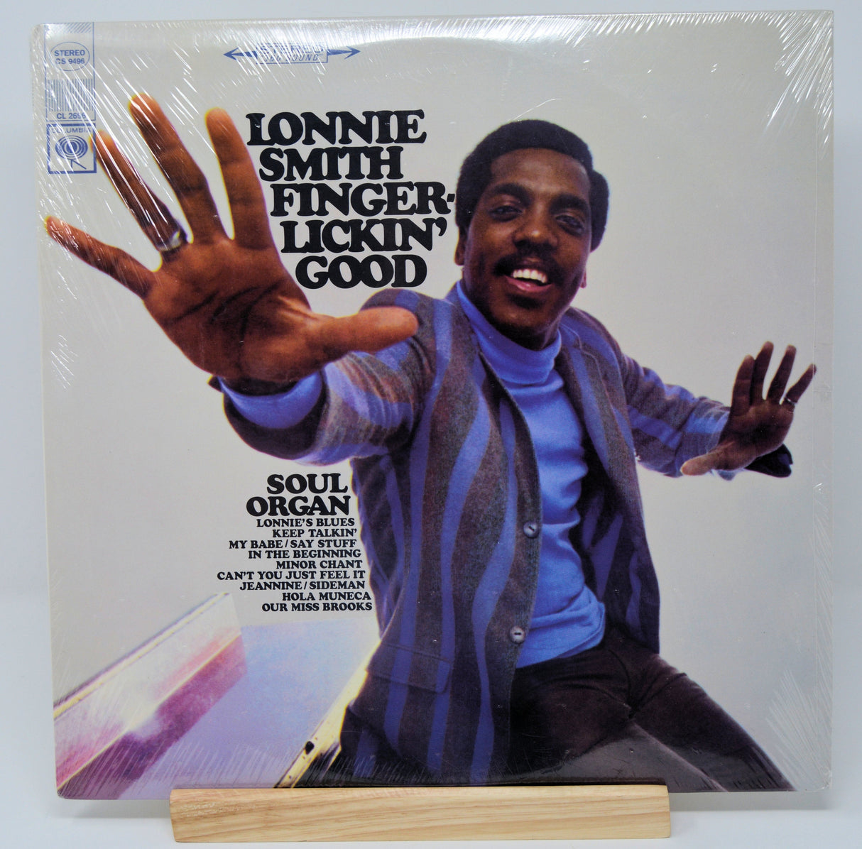 Front cover of Lonnie Smith 'Finger-Lickin' Good' LP featuring Lonnie Smith in vibrant attire reaching forward