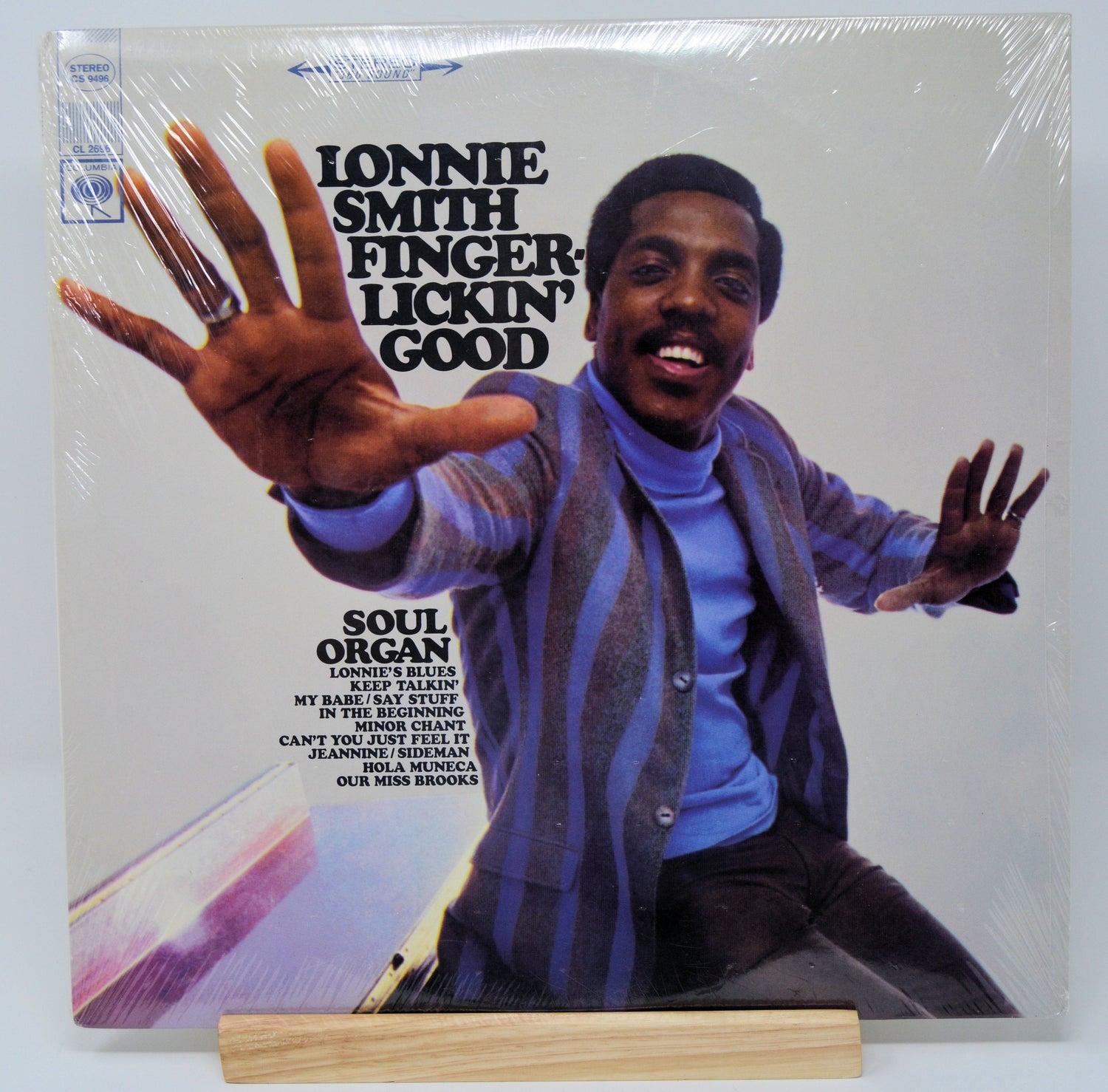Front cover of Lonnie Smith 'Finger-Lickin' Good' LP featuring Lonnie Smith in vibrant attire reaching forward