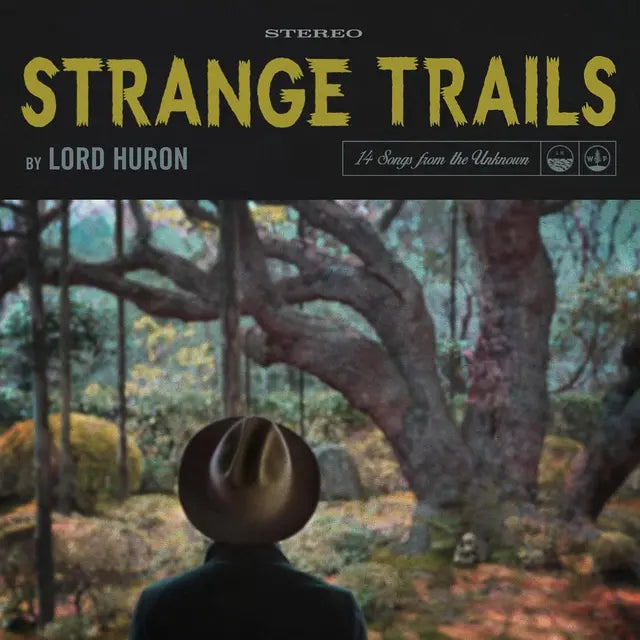 Cover art for Lord Huron's album Strange Trails featuring a person with a hat looking towards a forest scene.