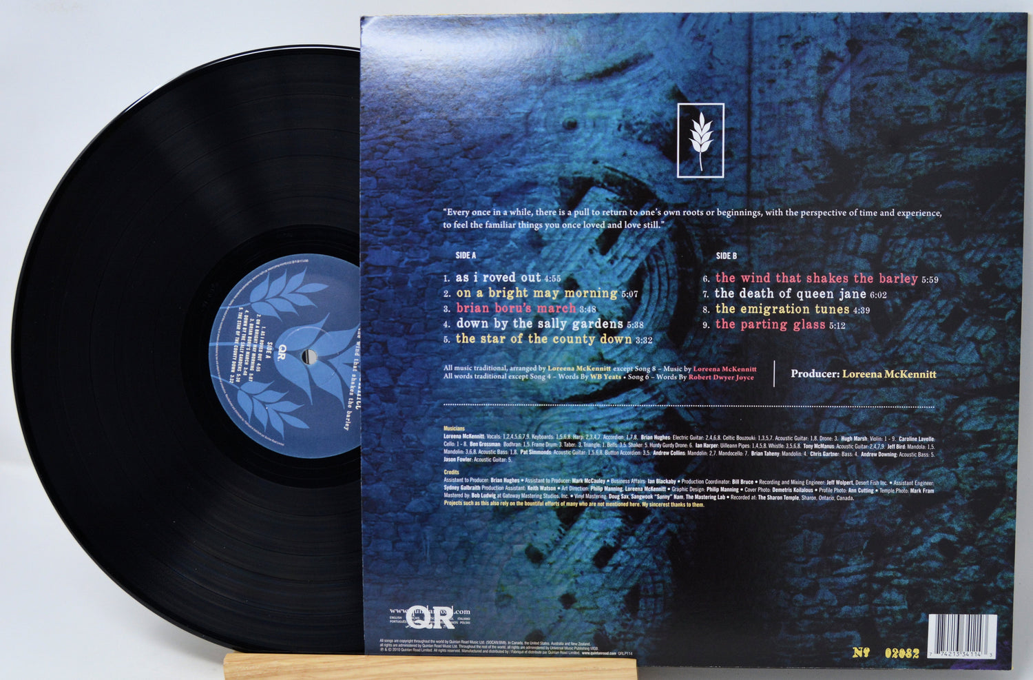 Vinyl record shown with the back of the album cover, featuring a black record partially pulled from the sleeve on a white background.