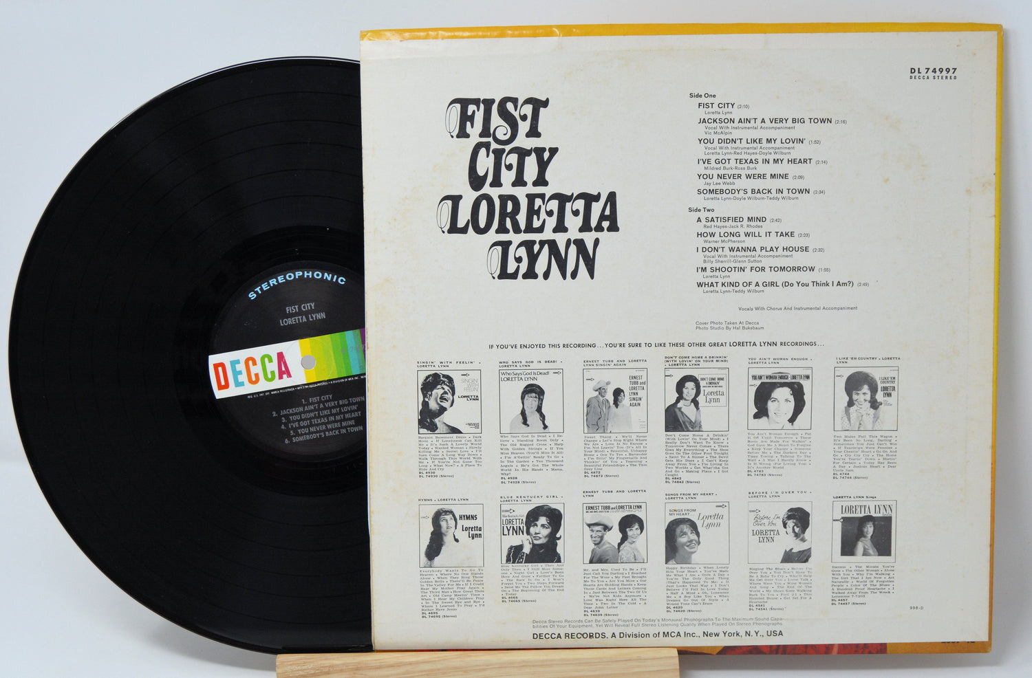 Back cover and vinyl record of Loretta Lynn's Fist City LP with tracklist and album details