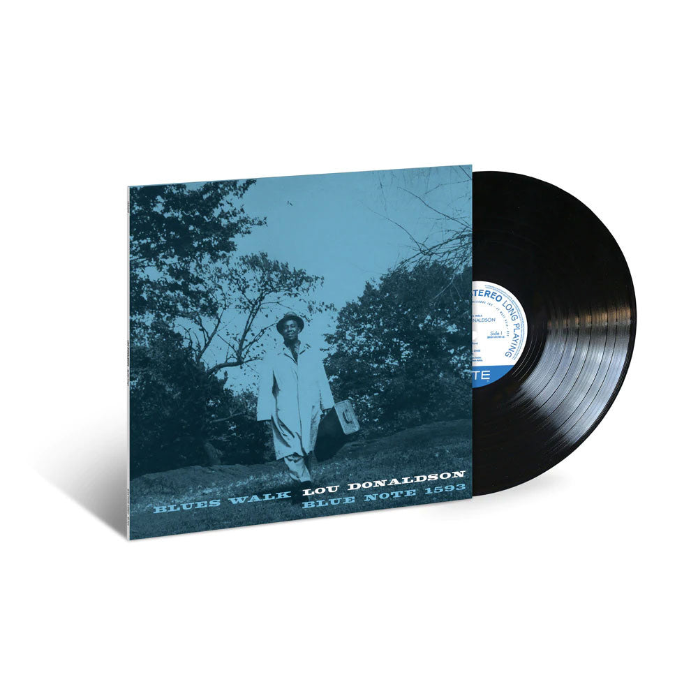 Vinyl record with a blue cover featuring a person walking through trees, on a white background.