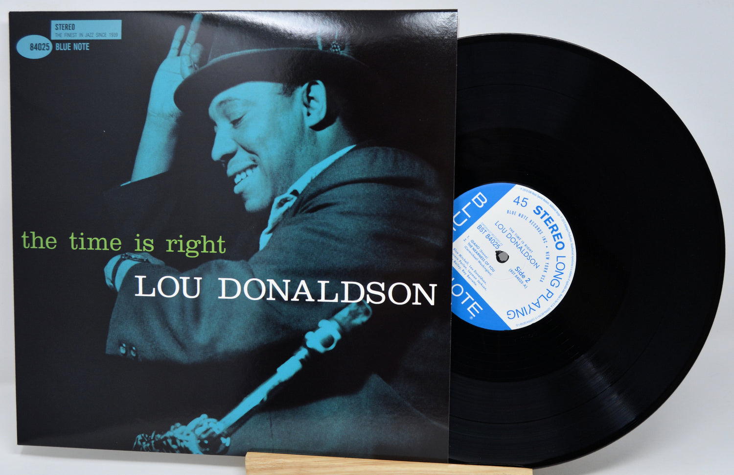 Lou Donaldson's 'The Time Is Right' vinyl record LP with its cover sleeve and the black record partially pulled out, displayed on a light gray background.