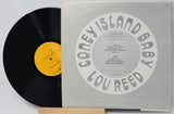 Vinyl record with a gray cover featuring text and a yellow label on a white background