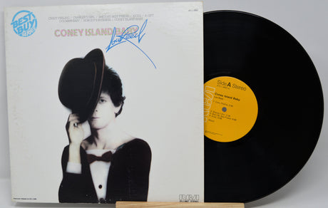 Vinyl record with a person wearing a hat and bow tie on the cover, displayed with the record visible.