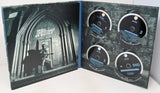 Open DVD case with four discs and a cover featuring a silhouette of a person playing guitar.
