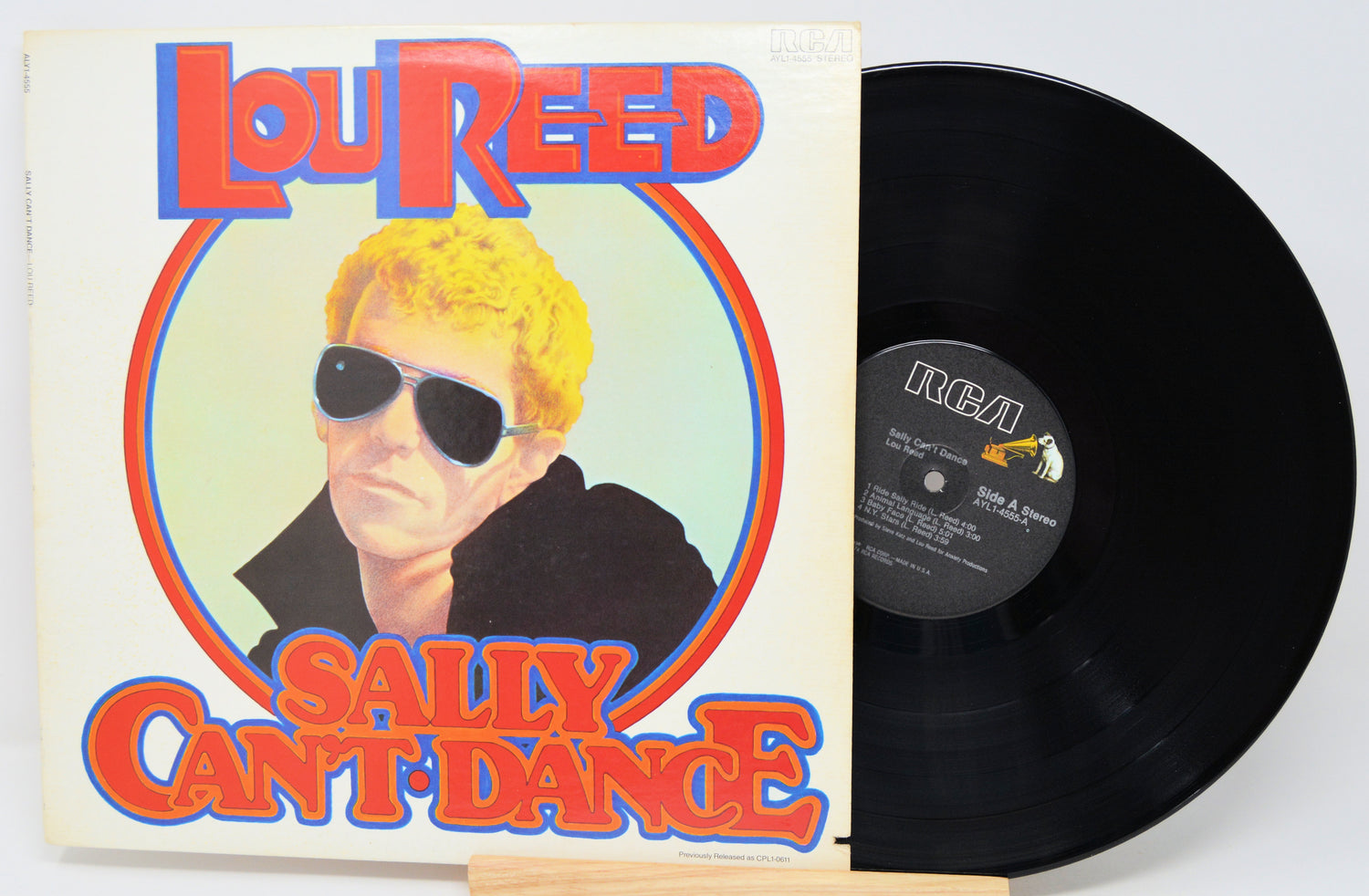 Vinyl record and cover for 'Sally Can't Dance' by Lou Reed on a white background