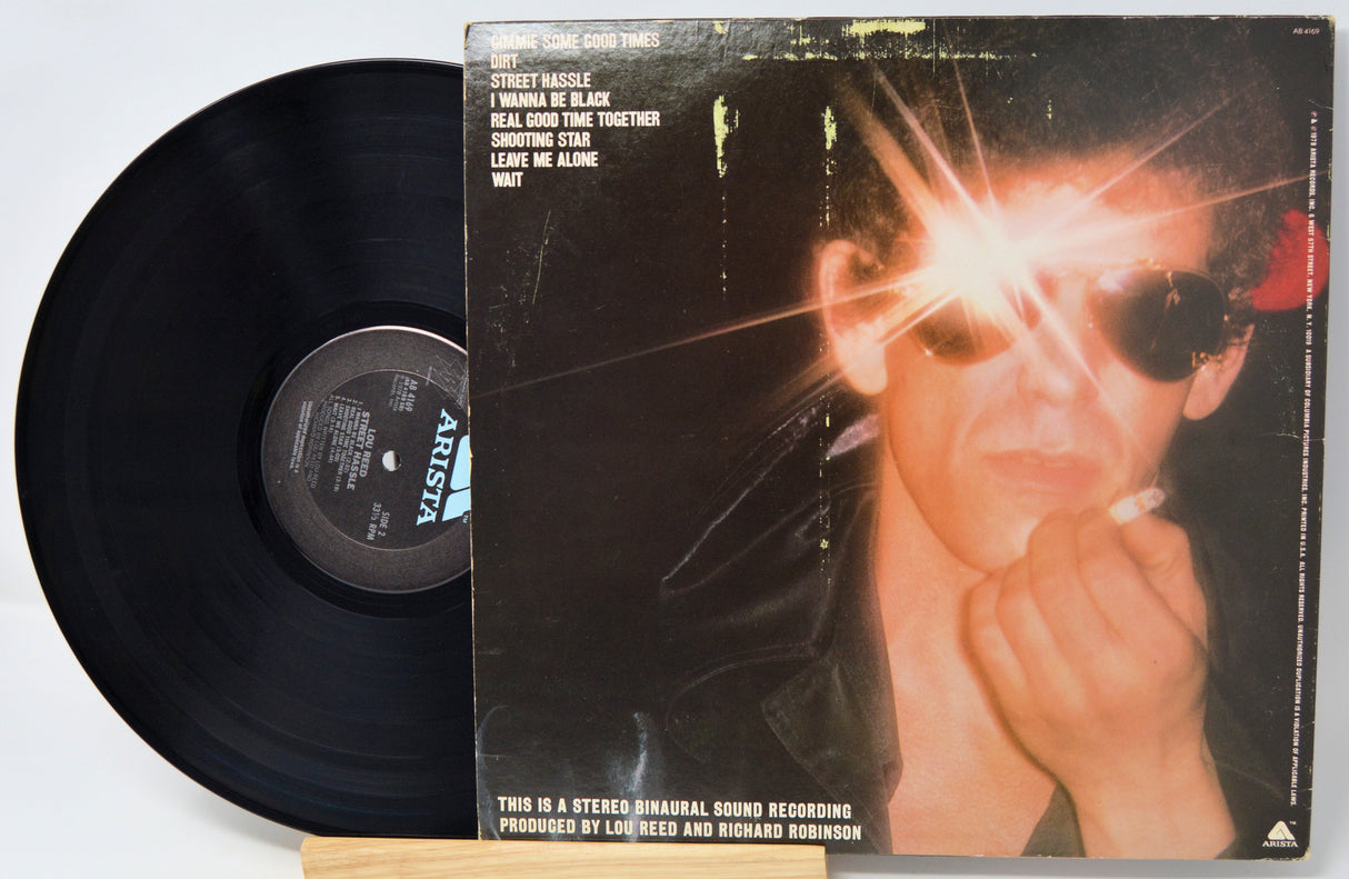 Vinyl record and its cover featuring a person with a bright light on a white background