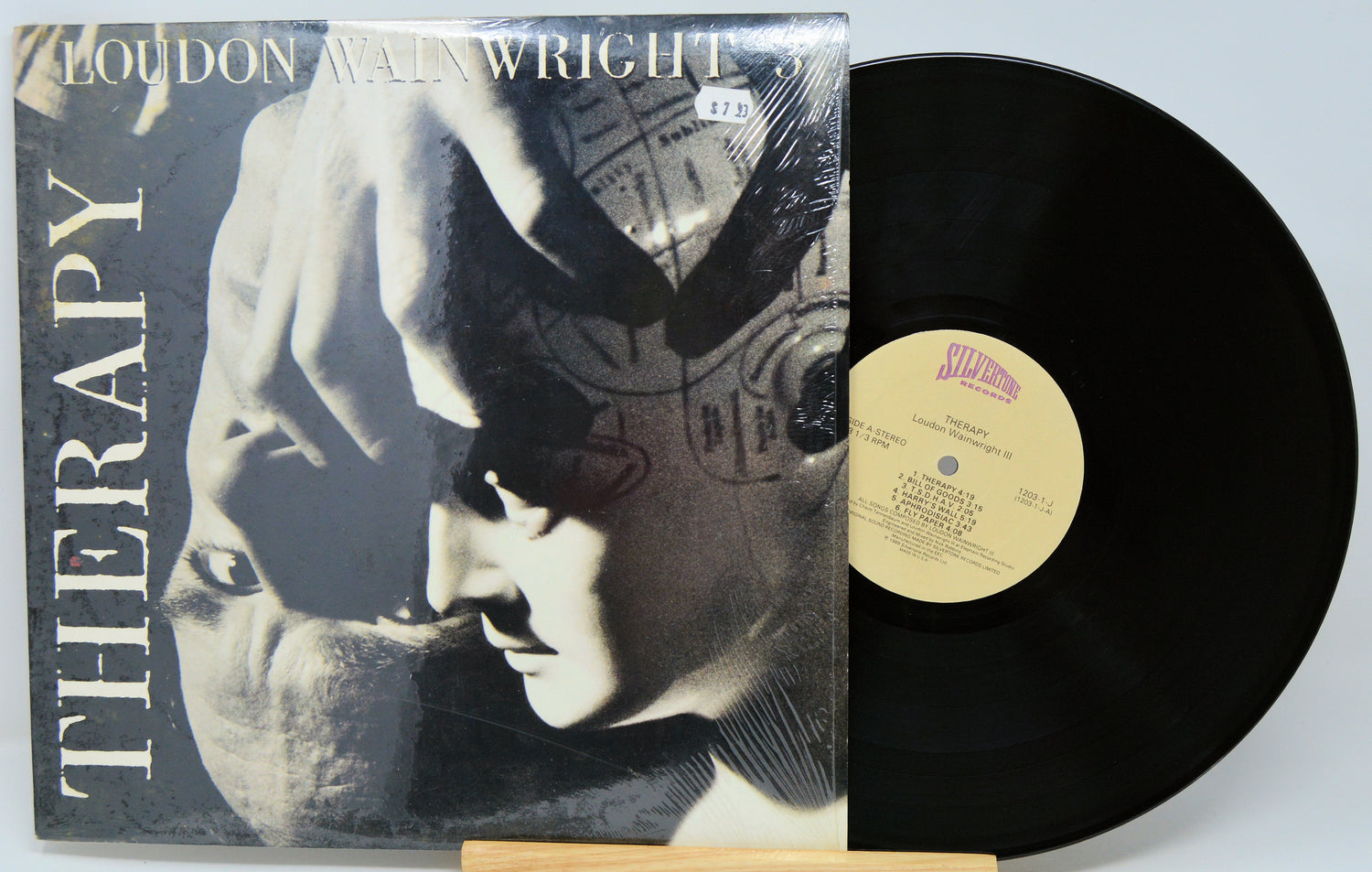 Vinyl record with cover featuring a black and white image of a person and the title 'Therapy' by Loudon Wainwright III.