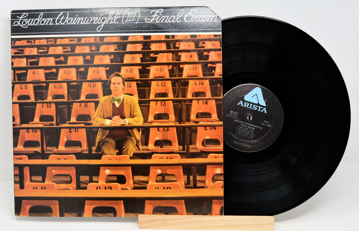 Front cover of Loudon Wainwright III Final Exam vinyl record featuring the artist in an empty lecture hall