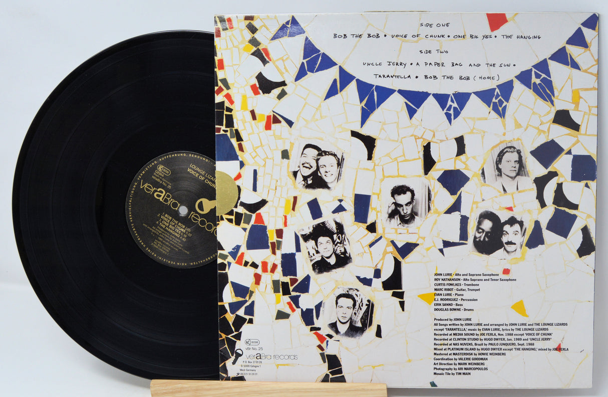 Vinyl record with a colorful cover featuring black and white portraits and geometric patterns.