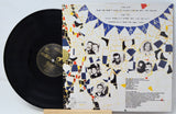 Vinyl record with a colorful cover featuring black and white portraits and geometric patterns.