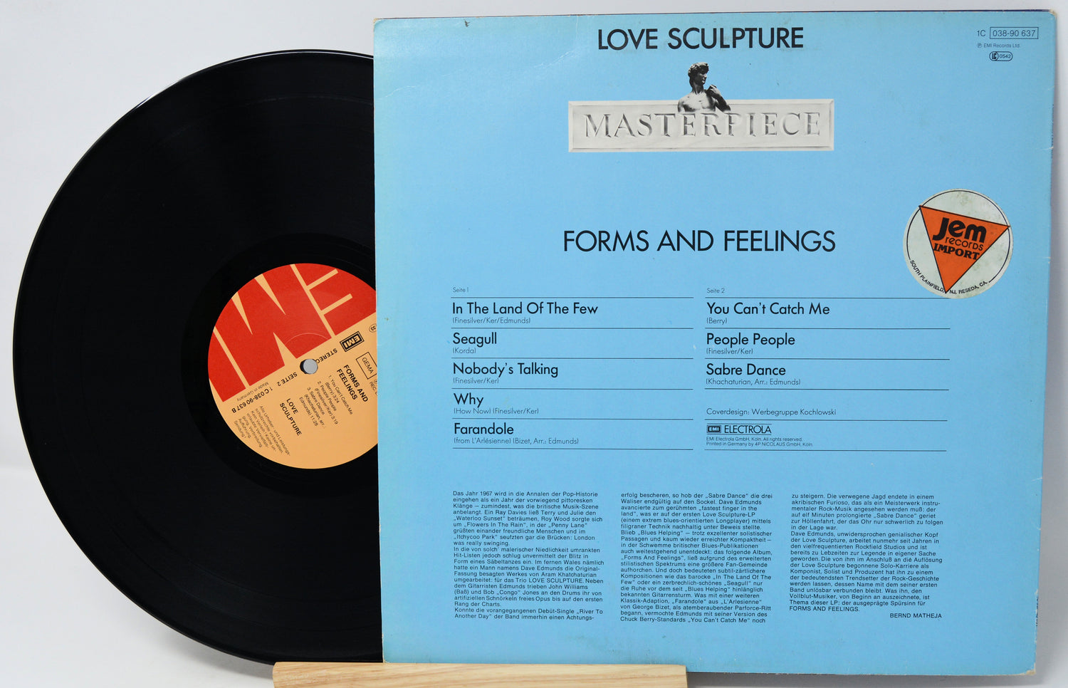 Vinyl record with blue cover featuring text and a logo on a white background