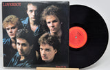 A vinyl record and its cover featuring members of the band Loverboy with the album title 'Keep It Up' displayed.