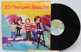 Vinyl record with cover featuring children and colorful text on a white background