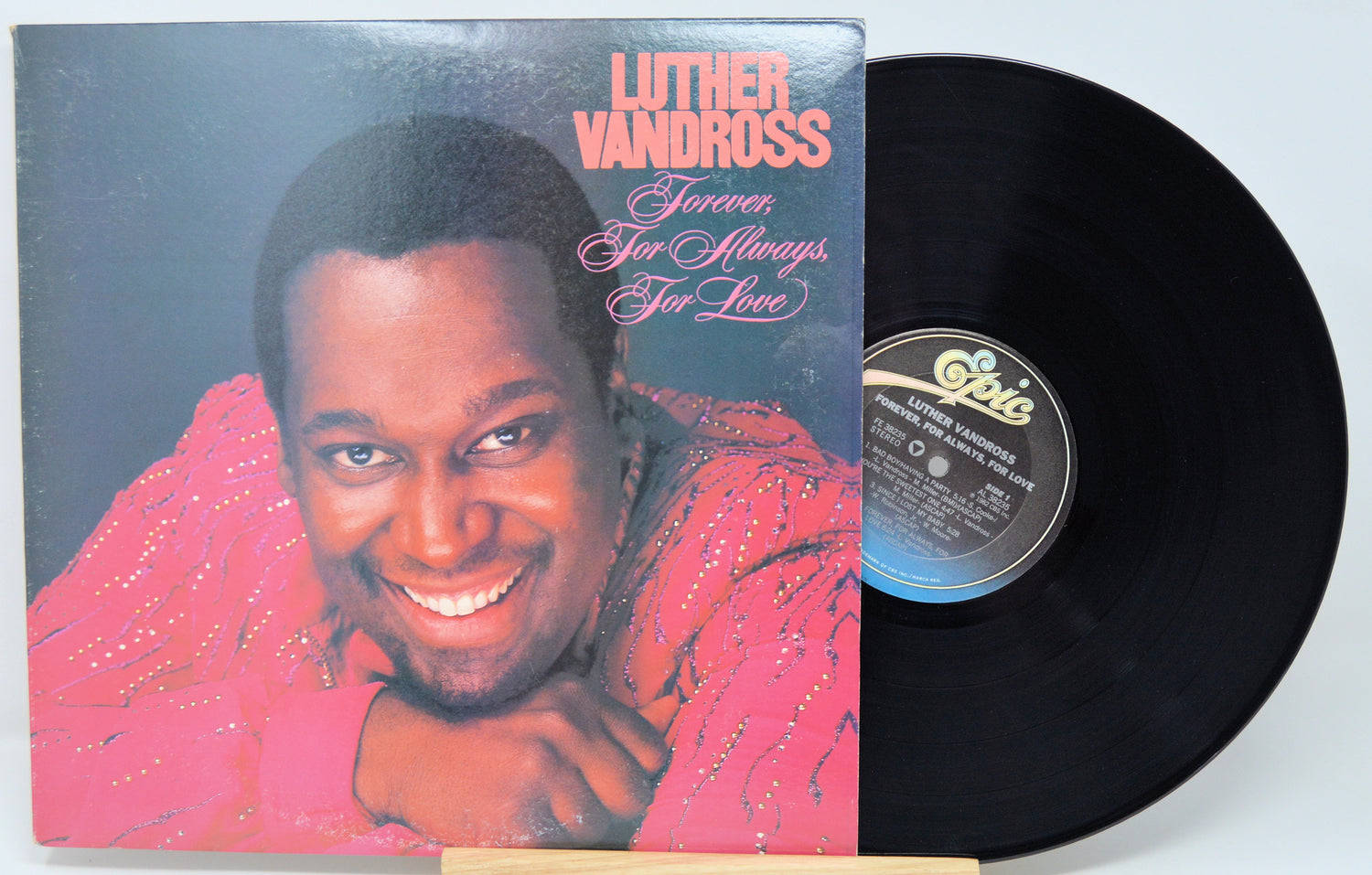 Vinyl record with cover featuring a smiling man, labeled 'Luther Vandross Forever Your Always Far Love'.