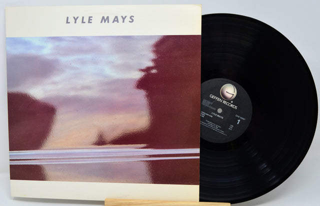 Vinyl record with cover featuring a blurred landscape and 'LYLE MAYS' text.