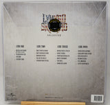 The back cover of a vinyl record sleeve for 'Lyrico Secreto' (Collected), featuring four song lists on a textured silver-gray background with the band's logo at the top.