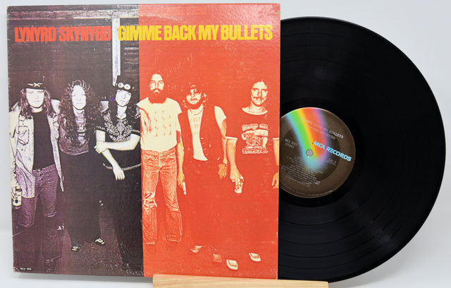 Vinyl record with cover featuring a band and rainbow label on a white background
