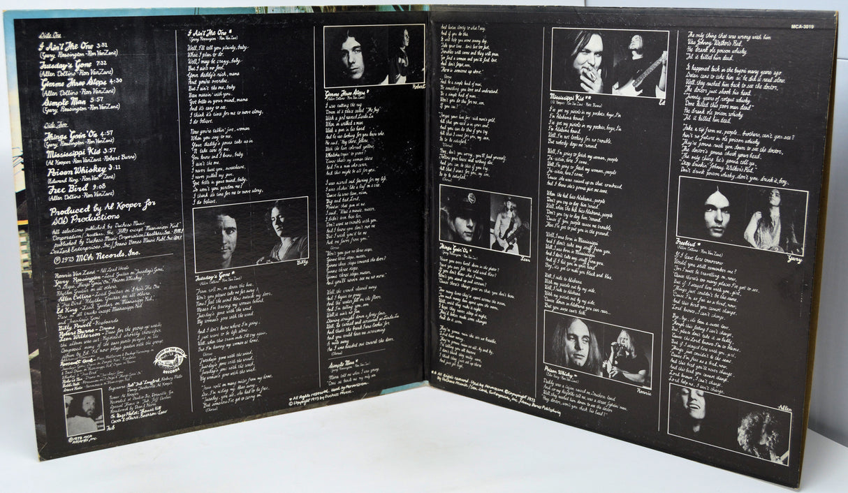 Back cover of a vinyl record with text and black and white images.