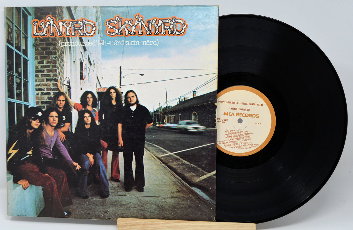 Vinyl record with cover featuring a group of people on a sidewalk.