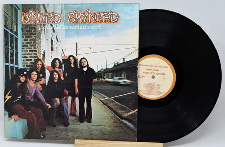 Vinyl record with cover featuring a group of people on a sidewalk.