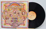 Vinyl record with colorful cover featuring psychedelic design and faces.