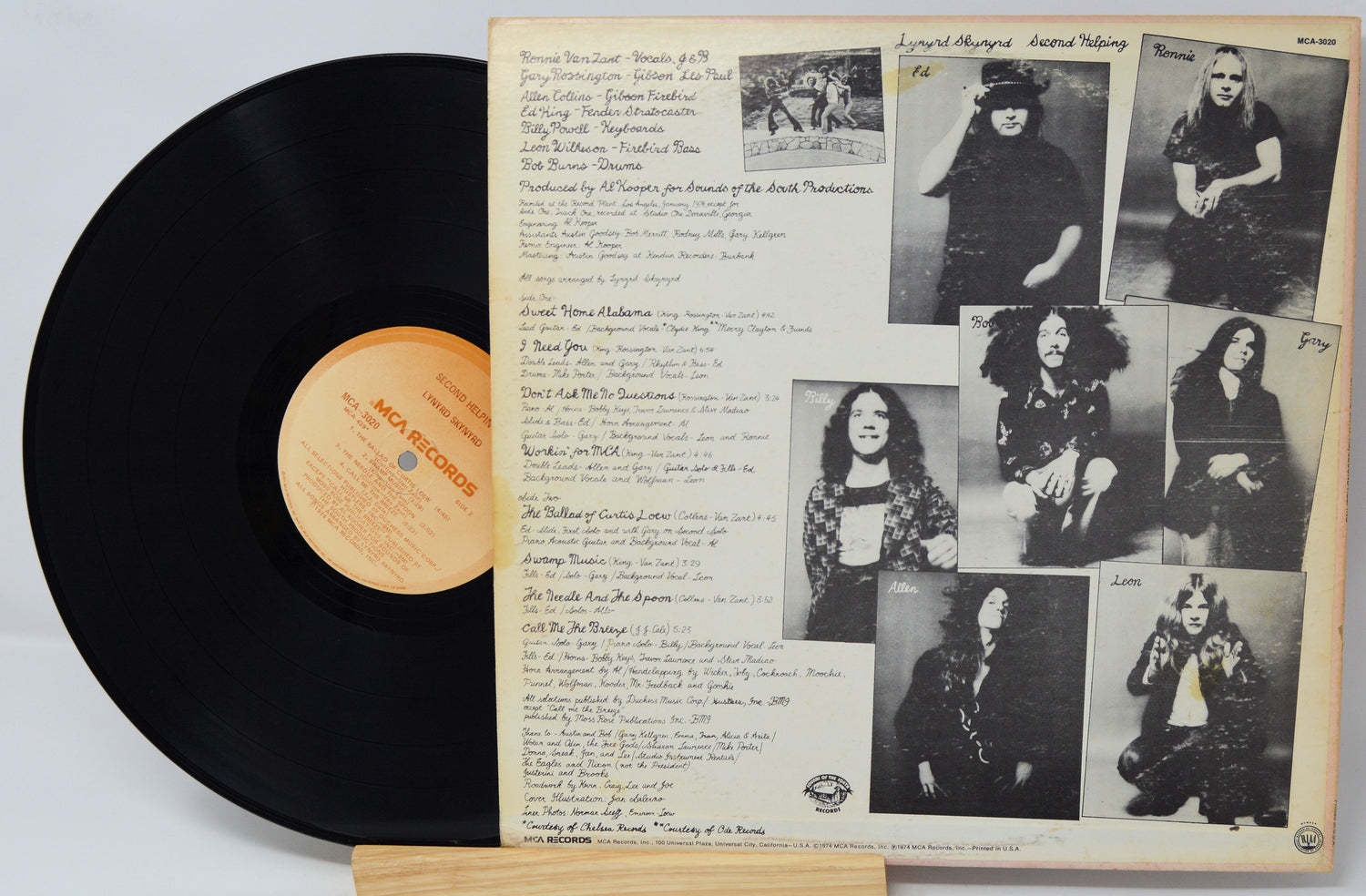 Vinyl record with a cover featuring black and white photos and text