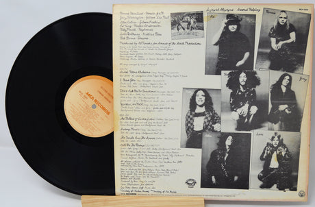Vinyl record with a cover featuring black and white photos and text