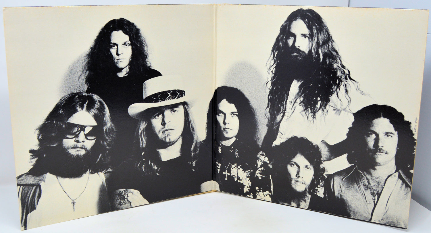 Album cover with black and white portraits of band members on a beige background