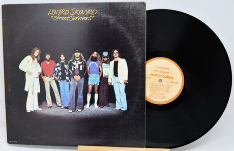 Vinyl record with cover featuring a band on a black background
