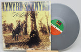 Front cover and silver vinyl LP of Lynyrd Skynyrd's The Last Rebel album, horseback scene artwork